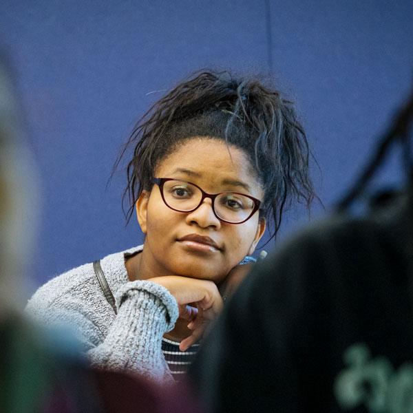 An Agnes Scott political science major student listens and looks ahead in class.