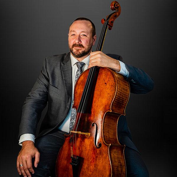 Barney Culver seated with cello